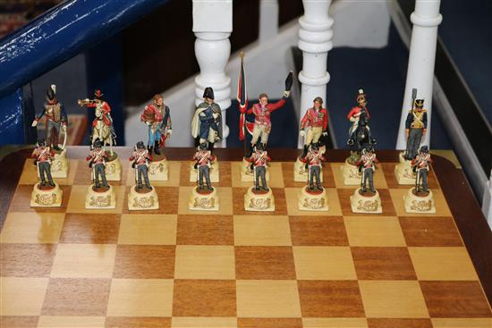 A Waterloo chess set by Charles Stadden, No. 27/250, in military style brass-bound mahogany games table on folding stand